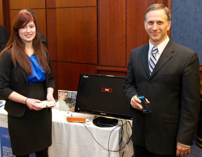Rachel Bartells and the CEO of Pulsar Informatics, Inc., Dr. Daniel Mollicone, demonstrate SleepFit, an app based on the alertness test currently used by astronauts on the ISS and adapted for long-haul truck drivers and other shift workers on Earth.